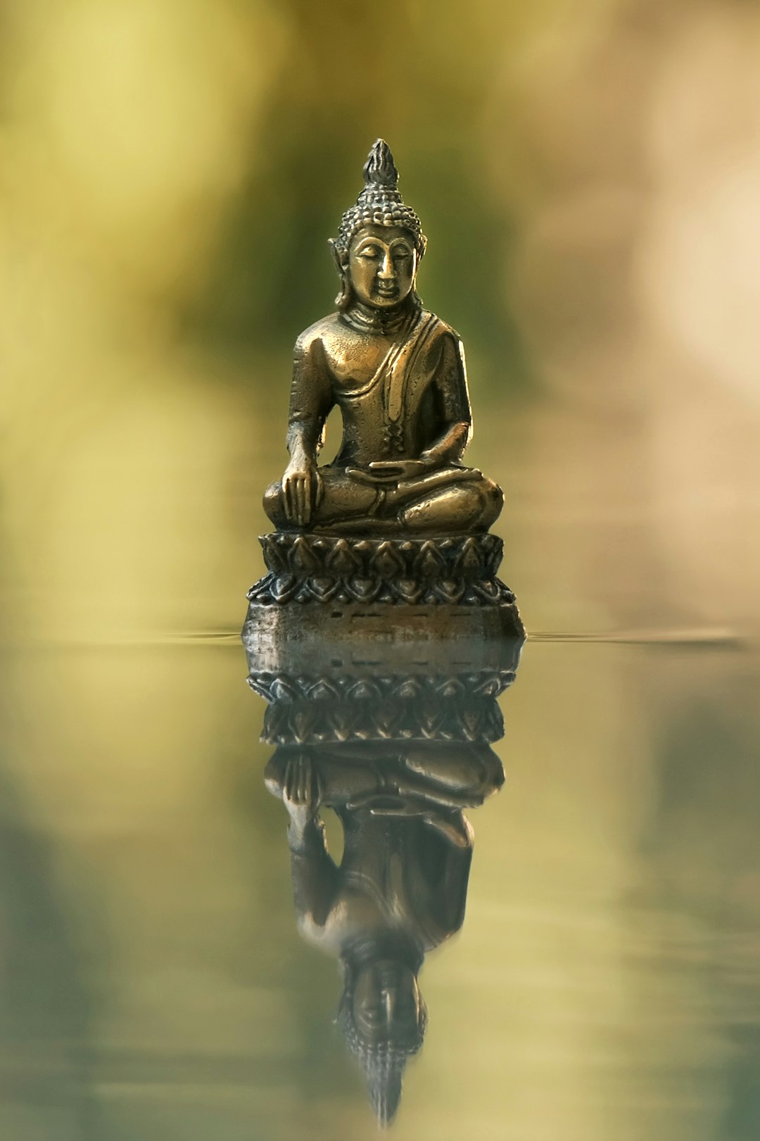 gallery-5 a-buddha-statue-sitting-on-top-of-a-body-of-water-naspzx1xl5u