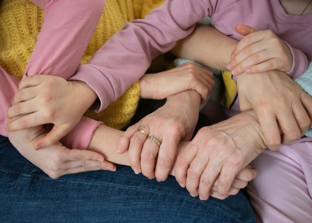 pexels photo 34995598 34995598 Multiple arms intertwined, symbolizing family unity and support across generations.
