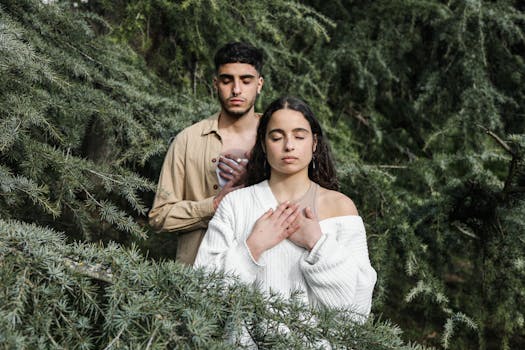 pexels photo 6962608 6962608 A couple meditates with eyes closed among lush green trees, embodying relaxation and love.
